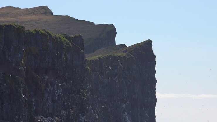 Le scogliere ornitologiche di Latrabjarg, Islanda, sono una delizia per il birdwatching; escursionisti che esplorano 4.