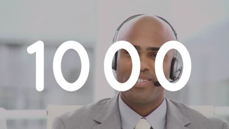 Animation-of-changing-numbers-over-man-wearing-phone-headset