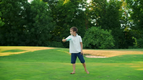 man, boy and woman playing frisbee in park. family throwing frisbee disc