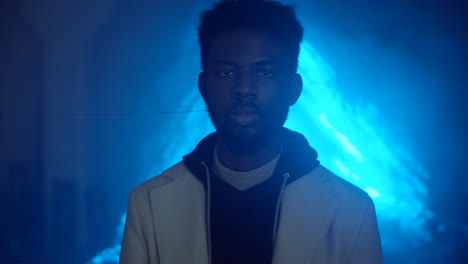 portrait of afro-american man against blue laser light