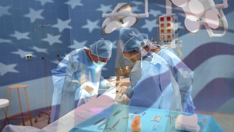 Animation-of-flag-of-united-states-of-america-waving-over-surgeons-in-operating-theatre