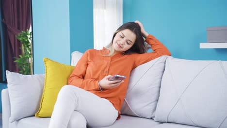Young-woman-resting-and-relaxing-at-home-sitting-on-sofa.
