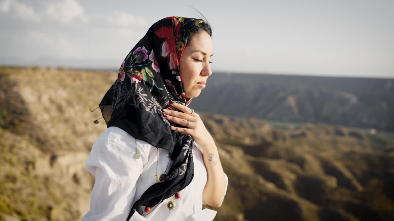 Woman wearing headscarf contemplating nature's serenity