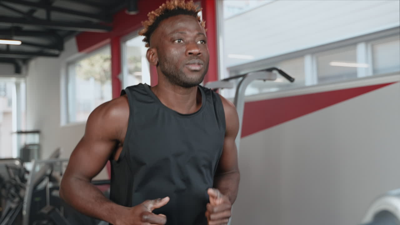 Man Running on Treadmill in Gym