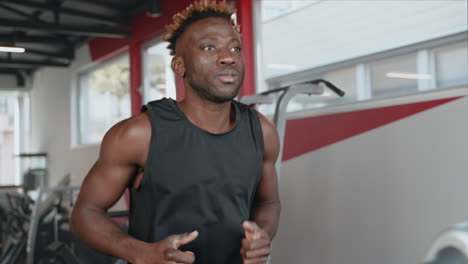 man running on treadmill in gym