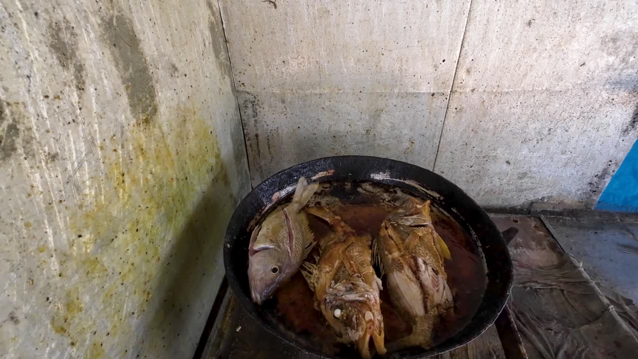 pescado frito crujiente con aceite en la sartén de cocción, cocina rústica al aire libre