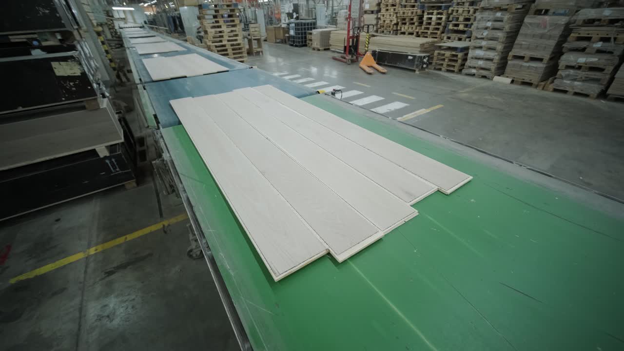 Wood Floorboards Moving Along Conveyor Belt in a Factory