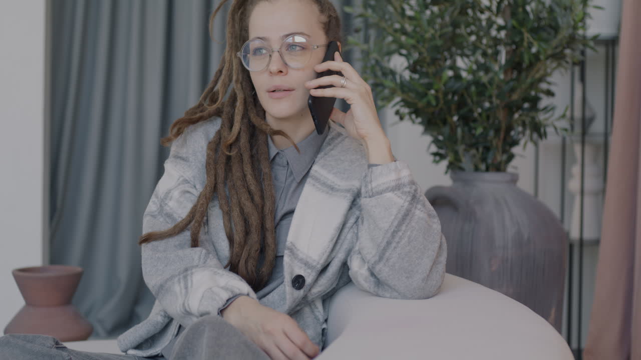 Woman Talking on Phone in a Modern Living Room