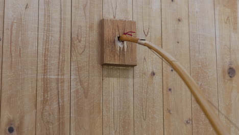 stringing a japanese yumi bow for kyudo japanese archery in wall stringing block