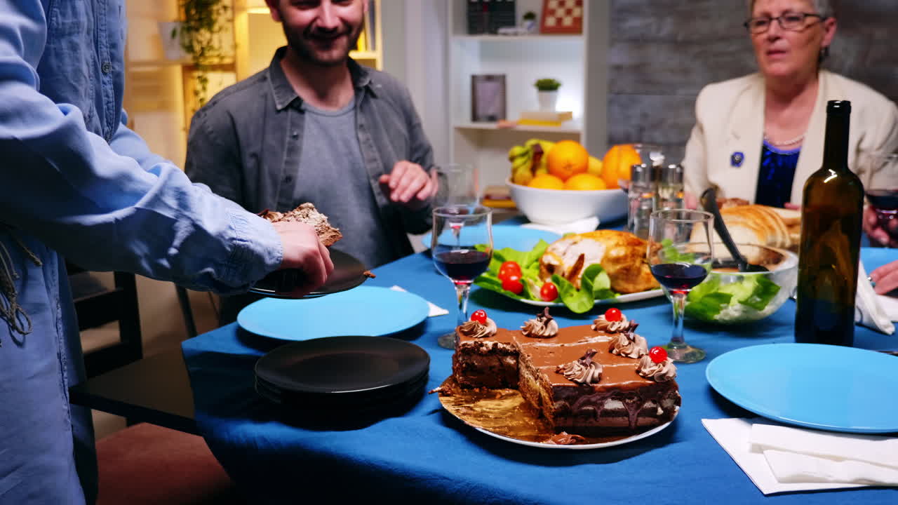 una mujer joven le da a su marido una rebanada de pastel.