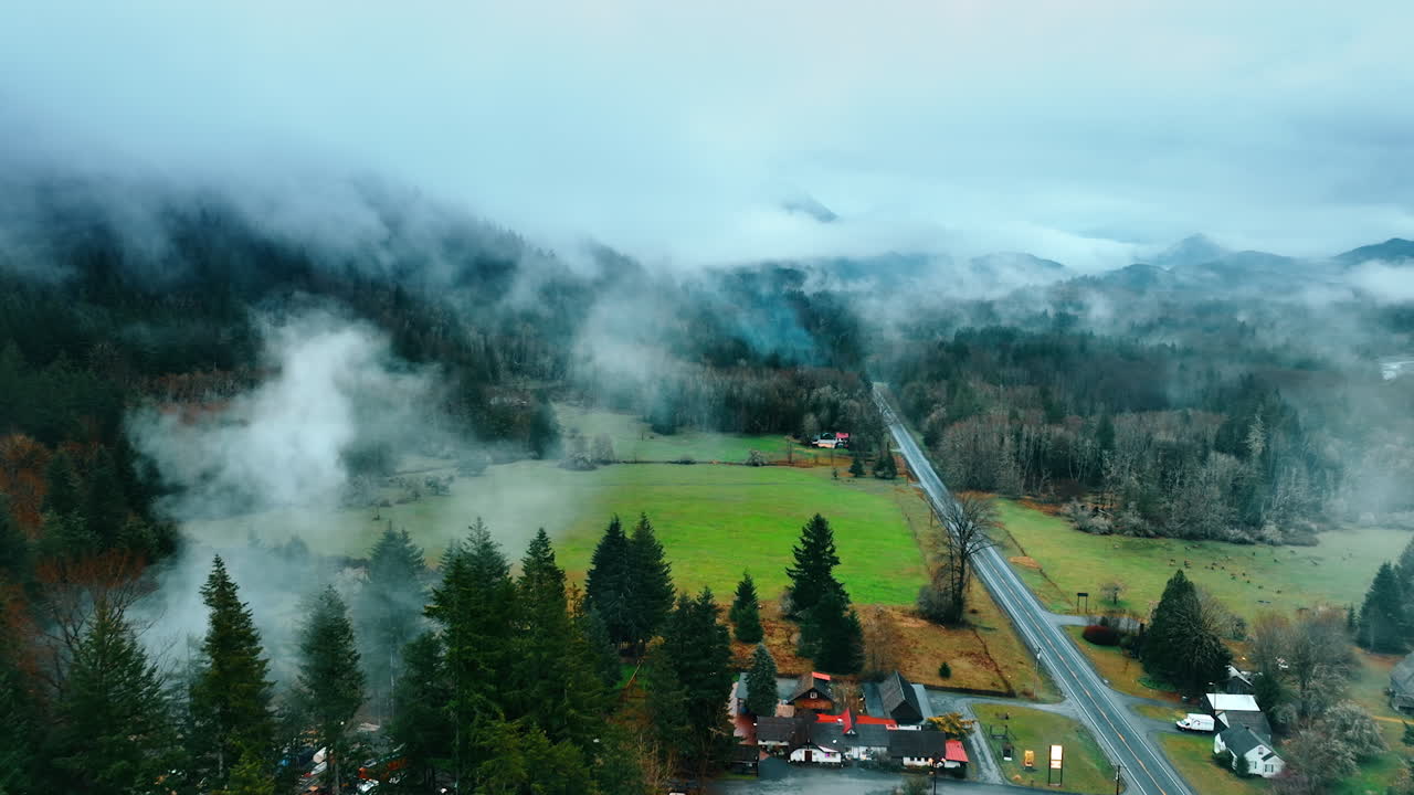 Cottages and parking lots in the valley of Mount Rainer national Park, Washington State, the USA. Top view on the misty forests covering the gorgeous mountains.