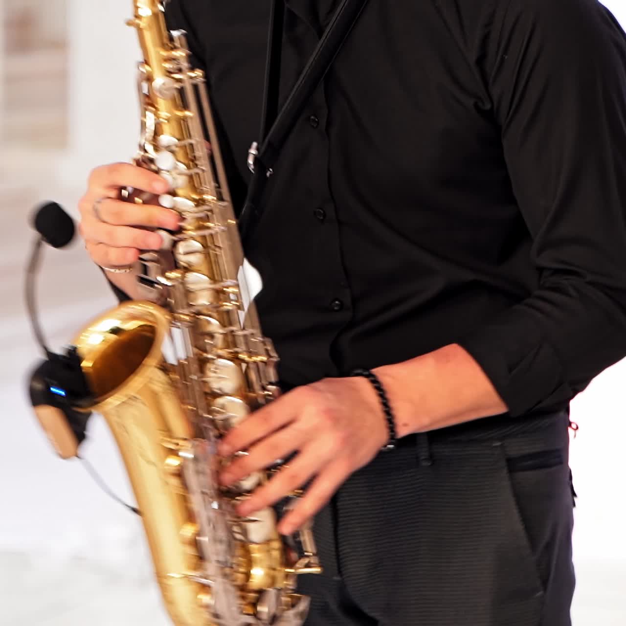 Saxophonist hands playing on saxophone
