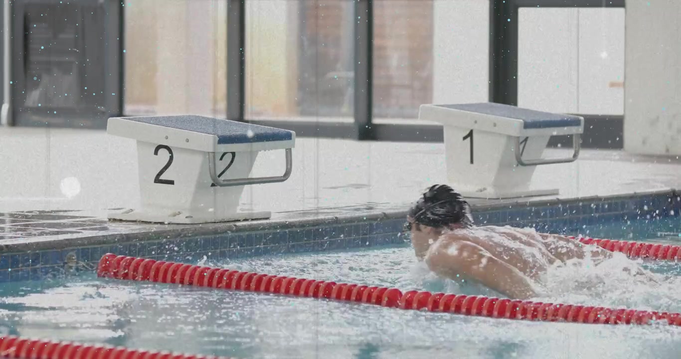 Swimmer diving at block 2 causing splash, executing butterfly strokes and gliding for training