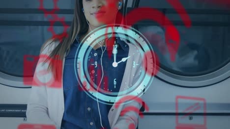 video compuesto de una joven biracial sonriente escuchando música en la lavandería y el icono del reloj