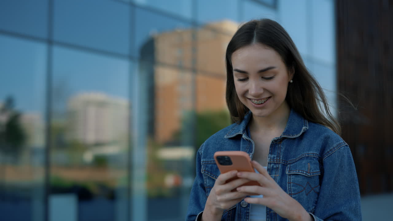 Young woman using a smartphone outside
