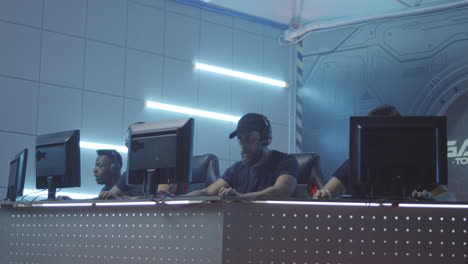 of multicultural female cybersport team winning game and cheering medium shot of young muslim female gamer and asian teammate playing in online video game with tense and focused look winning match cheering and pumping fists while celebrating victory