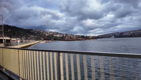 view of a city river and bridge on a cloudy day