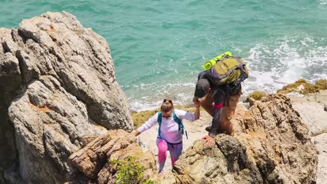couple hiking on coastal rocks