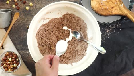 a delicious dessert, coffee hazelnut cream tart. made with espresso powder, chocolate crust and loaded with crushed hazelnut. adding milk o cream to the mixing bowl to make the chocolate pie crust