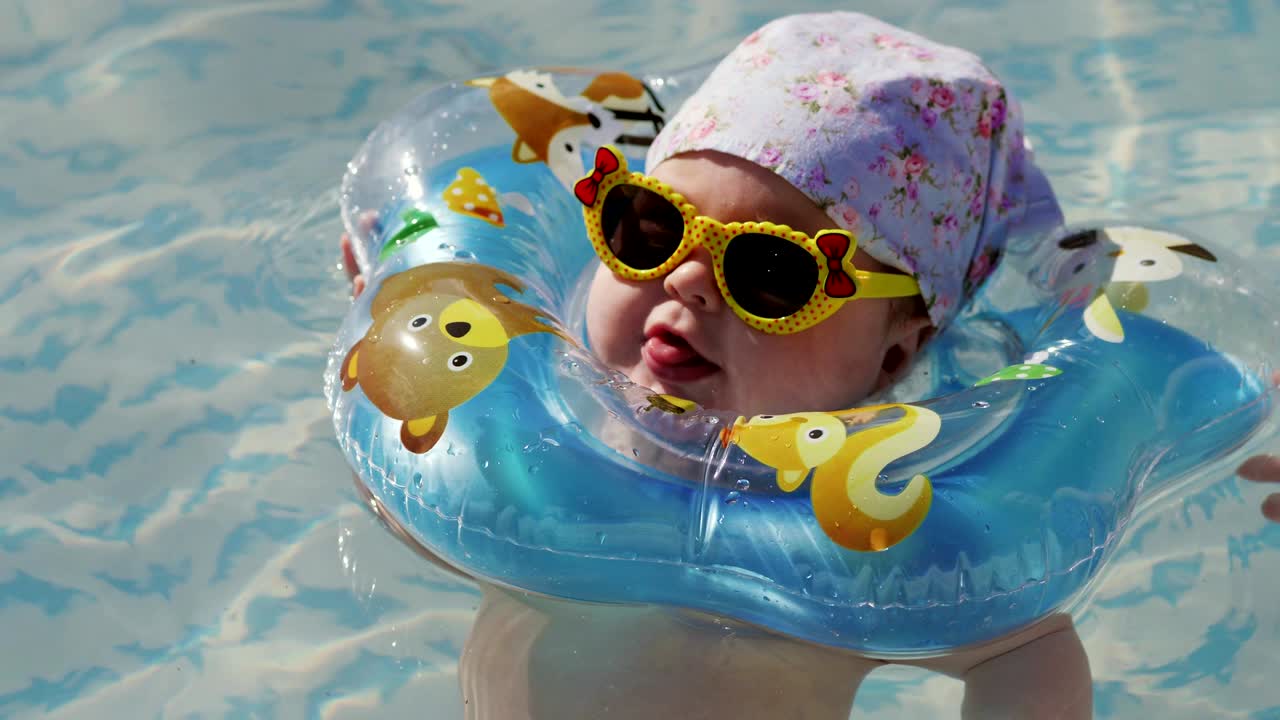 bebé nadando con anillo de natación en el cuello