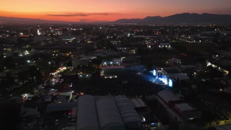 Aerial-view-around-a-concert-area,-evening-in-Mexico-city---circling,-drone-shot