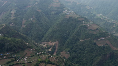 A-panning-view-of-many-small-towns-on-the-steep-hillsides-of-the-Himalayan-Foothills-in-Nepal