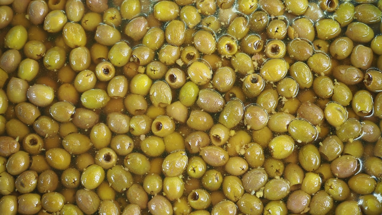 Close-up of Green Pitted Olives Soaking in Brine