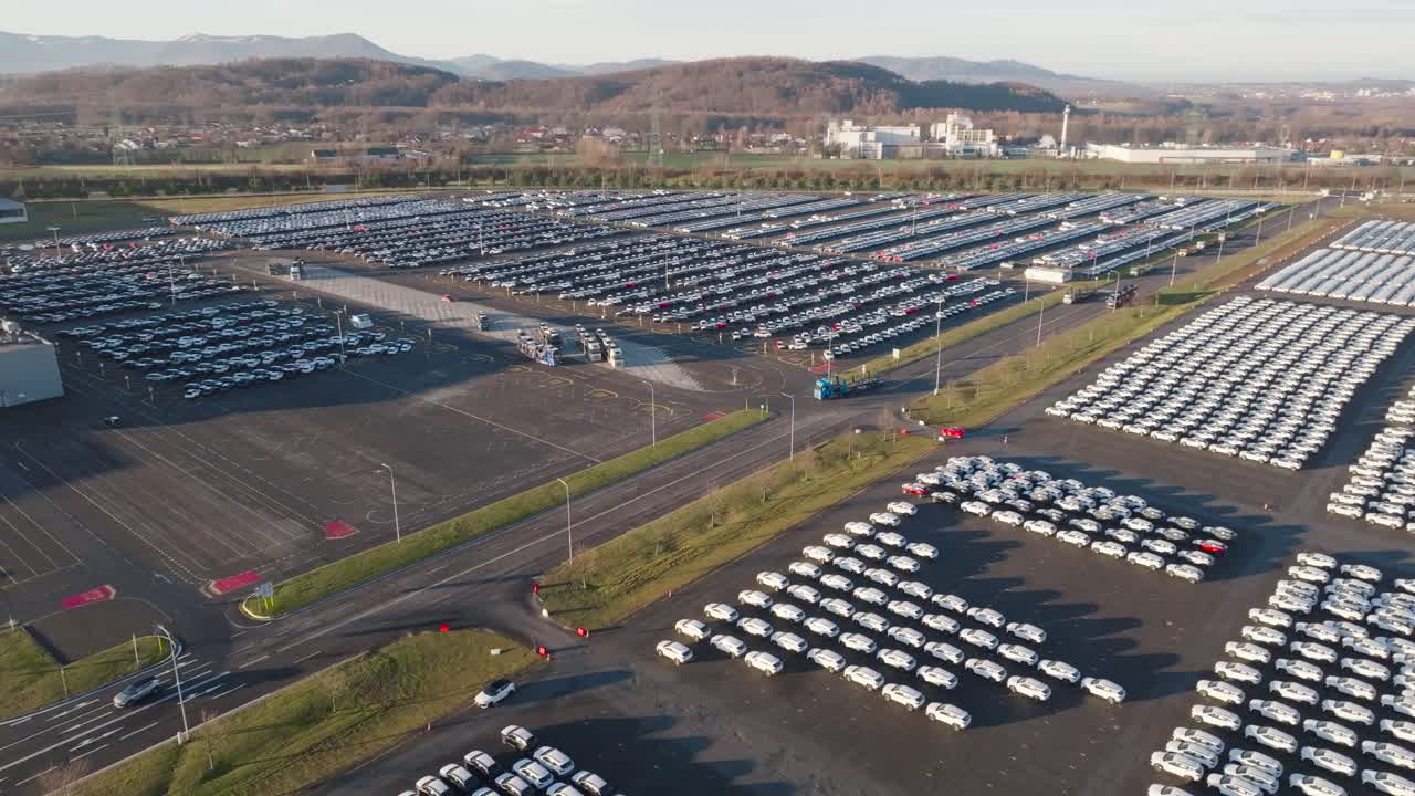 Aerial - parking lot territory filled with mass production vehicles