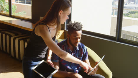 Front-view-of-young-cool-mixed-race-business-team-planning-and-sitting-on-couch-of-modern-office-4k