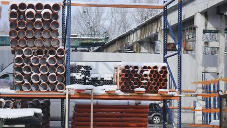 orange pvc pipes stacked in construction site