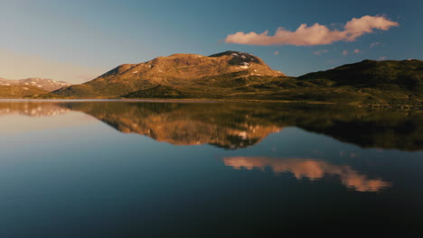 the beautiful light of the sunrise over the mountains by vavatnet lake in norway