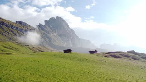 Fly-over-drone-shot-of-of-some-houses-in-the-middle-of-the-forest-in-the-Dolomites-Italy