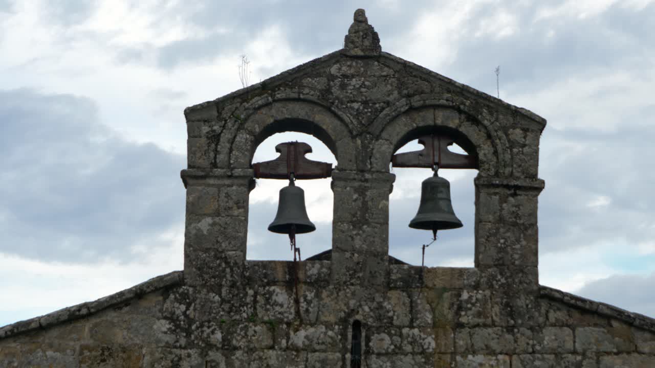Santiago de Gustei bell tower silhouette, showing iconic twin bells in Galicia, Spain