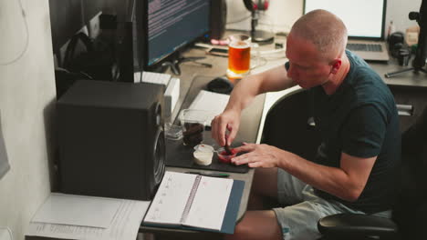 man eating snack at home office desk