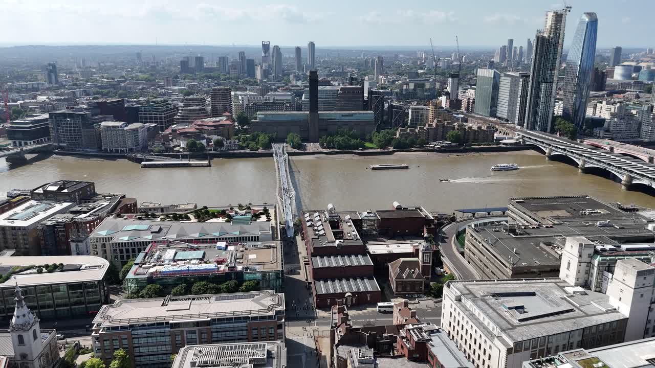 Aerial flyover of St. Paul’s Cathedral in London, gliding towards Millennium Bridge and the River Thames. Stunning cityscape with iconic architecture and historic landmarks in cinematic view