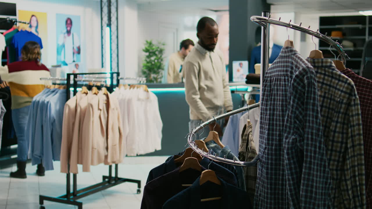 People shopping for men's fashion apparel in a boutique clothing store