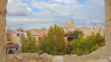 the cityscape of tarragona, catalonia captured from the remains of the medieval castle on a cloudy day making the scene appear like painting