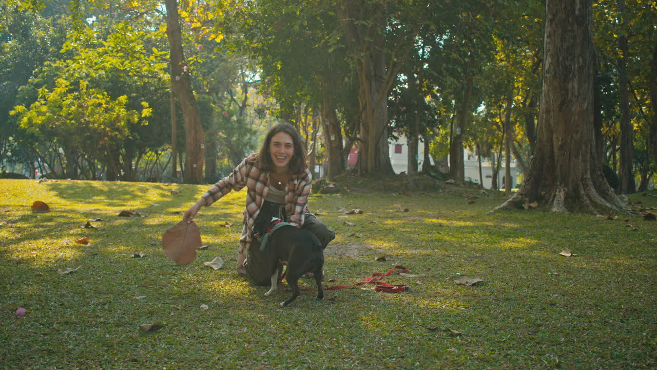 Woman Playing with her Dog in a Park