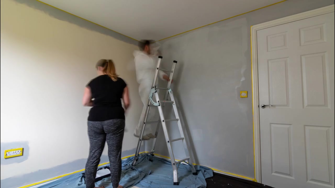 Timelapse of couple decorating and painting a room