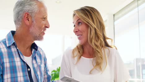couple is smiling and holding a smartphone