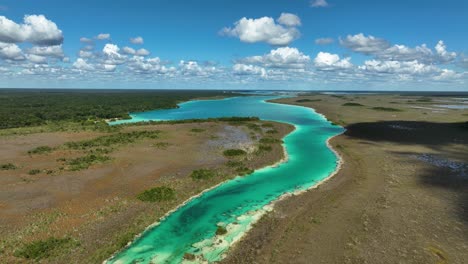 rising over the bacalar rapids, sunny day in quintana roo, mexico - aerial view