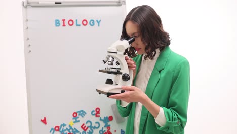 woman using a microscope in a biology setting