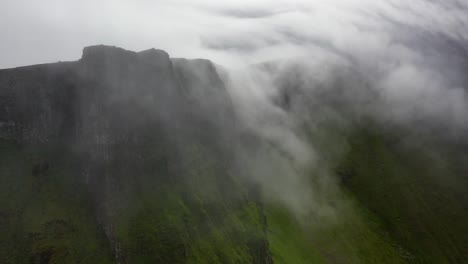 Cloudy-mountain-peak-atmospheric-landscape-in-remote-Faroe-Islands,-aerial-view