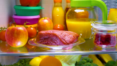 Fresh-raw-meat-on-a-shelf-open-refrigerator