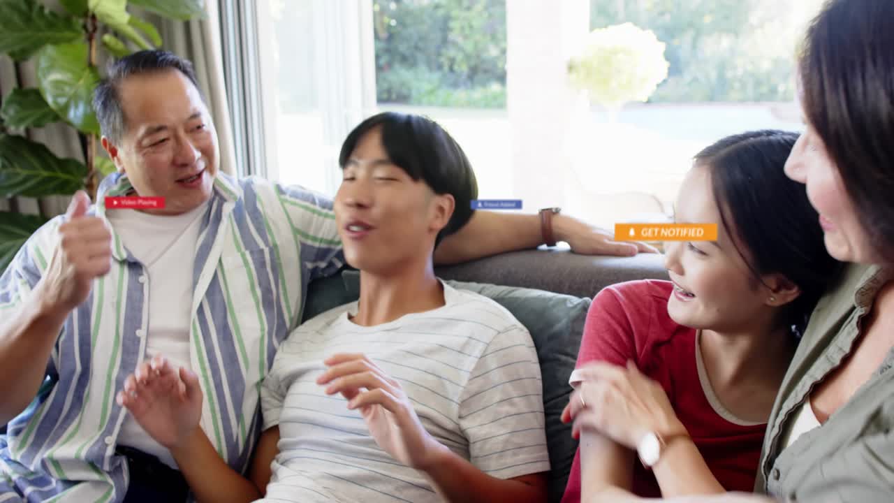 Family of four tapping phone, watching together, tech alerts floating around family, sharing smiles