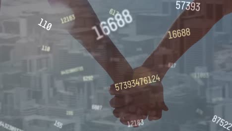 Animation-of-numbers-processing-over-people-holding-hands