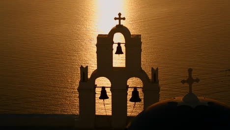 a beautiful sunset behind a greek orthodox church on the greek island of santorini 2