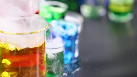 beakers with colorful liquids and dry ice reaction