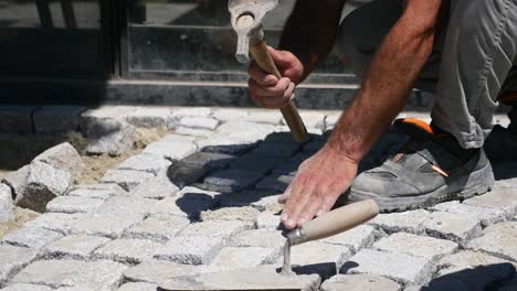 construction worker laying paving stones