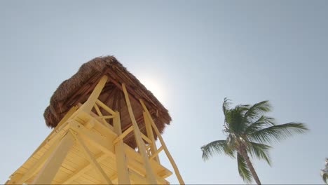 bright yellow watch tower on tropical beach